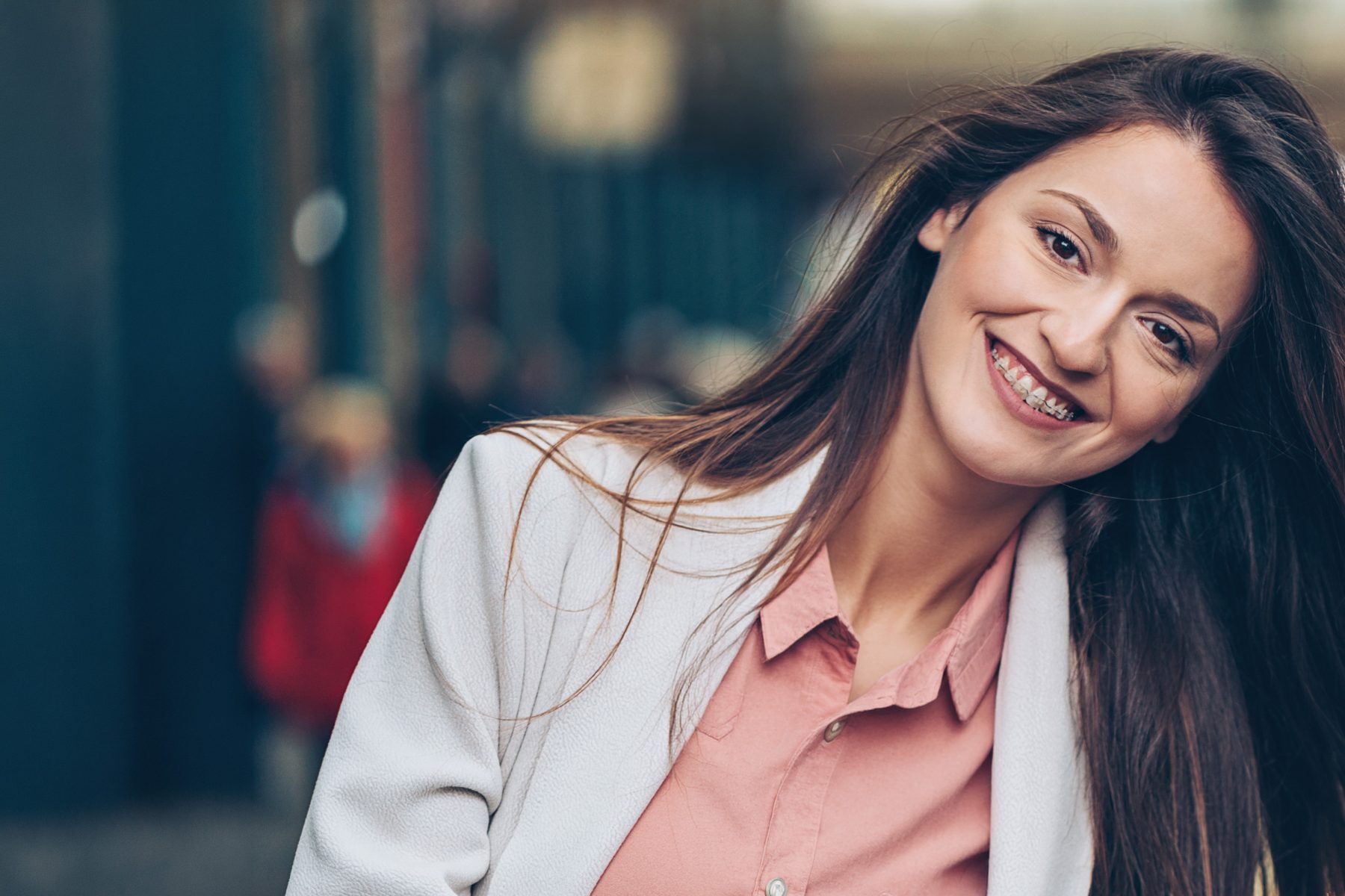 A woman smiling with braces - adult orthodontics