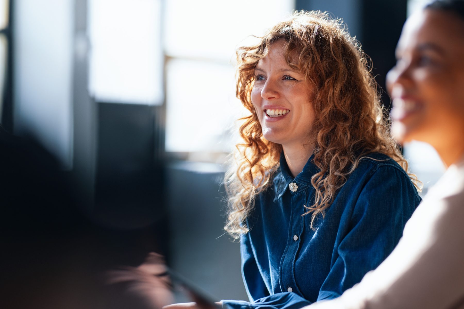 A woman smiling in conversation - dental bridges